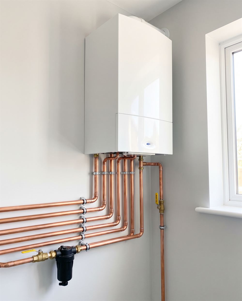 A newly fitted combi boiler with neat copper pipework